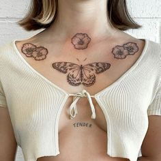 a woman with butterfly tattoos on her chest