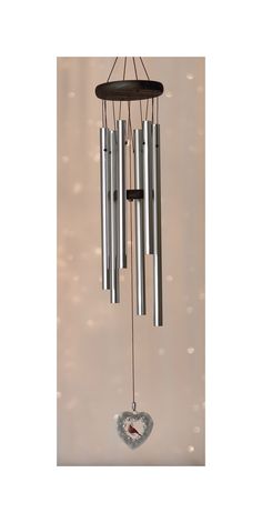 a wind chime hanging from the side of a wall