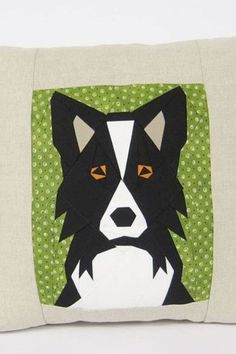 a black and white dog is on a green pillow with polka dot border around it