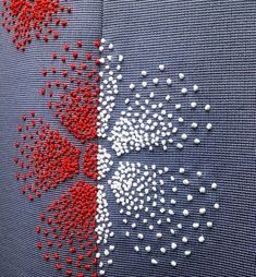 the design is made up of red, white and blue dots on fabric with stitching