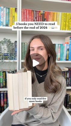 a woman sitting in front of a bookshelf holding an open book with the caption, 5 books you need to read before the end of 2012