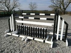 a black and white fence sitting on top of gravel