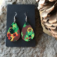 "\"TROPICAL MONKEY TEARDROP DANGLE EARRINGS\" Made out of up-cycled wood, with a sublimated tropical monkey print.  The earrings are fun, playful, vibrant, and the bold colors make for a nice statement piece. These earrings are perfect for everyday wear, stocking stuffers, or a just because gift. Approximate Dimensions: 1 1/2\" X 1\" (without drop) 2 3/8\" X 1\" (with drop) Materials: Upcycled Wood Hypoallergenic Stainless Steel Earring Back Facts: Sublimated Design Resourcefully Sourced Materia Retro Teardrop Earrings As Gift, Handmade Yellow Teardrop Earrings, Handmade Yellow Teardrop Earrings Gift, Handmade Yellow Teardrop Earrings As A Gift, Yellow Teardrop Earrings For Everyday, Yellow Teardrop Everyday Earrings, Upcycled Wood, How To Clean Earrings, Monkey Print