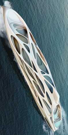 an aerial view of a futuristic boat in the middle of the ocean with water behind it