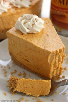 a slice of pumpkin cheesecake on a plate with a fork next to the pie