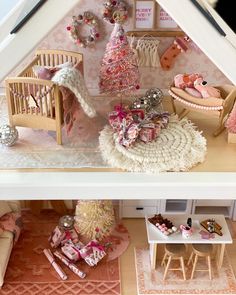 a doll house with furniture and accessories in the interior, including a crib for a baby's room