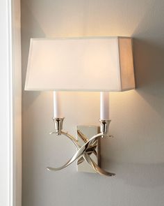 a wall light with a white shade on it