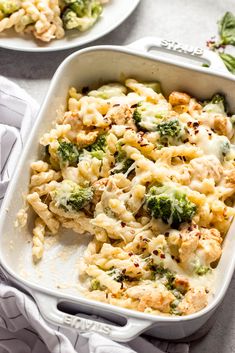 two white casserole dishes filled with chicken and broccoli covered in cheese