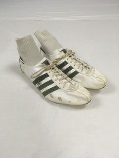 vintage 1970s track sneakers Adidas Quebec made in France original laces dark green suede stripes on white leather w/marks, scuffs, one spike gone rubber partial sole is still flexible front of bottom is hard plastic w/spikes measures, insole-10 7/8" sole-11 1/4" width-3 1/2" height at heel-3 1/4" Vintage White Adidas Sneakers, Vintage Running Sneakers, Vintage Sports Sneakers With Three Stripes, Vintage Style Sneakers With Three Stripes For Sports, Adidas Vintage Shoes, 70s Sneakers, 70s Adidas, Track Sneakers, White Leather Shoes