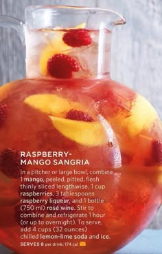 a pitcher filled with raspberry sangria on top of a table