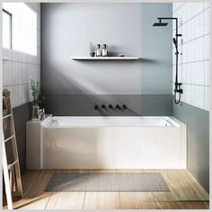 a white bath tub sitting under a window next to a ladder