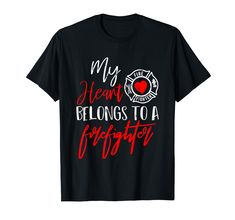 a black t - shirt with the words my heart belongs to a firefighter on it