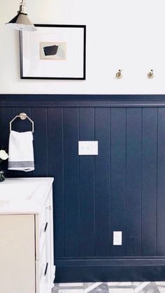 a white sink sitting under a bathroom mirror