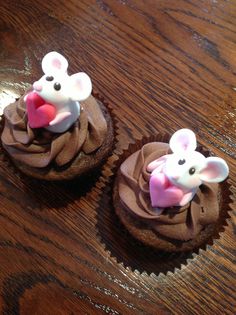 two cupcakes with chocolate frosting decorated like mice