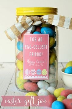 a jar filled with easter eggs on top of a table