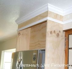 a refrigerator and cabinets in a kitchen under construction