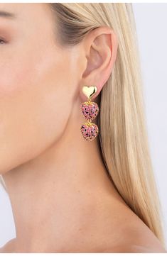 Add a dose of sweetness to your date-night ensemble with these polished earrings with heart-shaped drops. 2" drop Post back 18k-gold plate/cubic zirconia Imported Yellow Gold Heart Earrings For Valentine's Day Party, Party Yellow Gold Heart Earrings, Valentine's Day Cubic Zirconia Dangle Heart Earrings, Valentine's Day Cubic Zirconia Heart Dangle Earrings, Valentine's Day Gold Plated Heart Earrings, Valentine's Day Cubic Zirconia Earrings, Gold Cubic Zirconia Heart Earrings For Party, Valentine's Day Heart Drop Earrings With Cubic Zirconia, Strawberry Heart