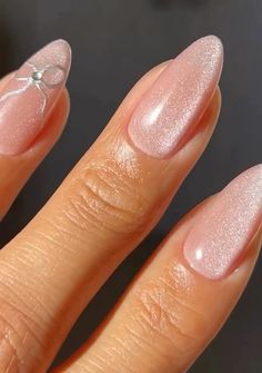 a woman's hand with pink nail polish on it