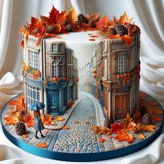 a cake decorated with autumn leaves and an image of a man walking down the street