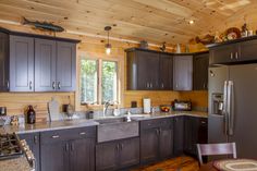 a kitchen with wood paneling and stainless steel appliances