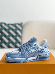 Step into iconic style with these LV Trainer-inspired sneakers reimagined in cool blue monogram denim. This contemporary take on a classic silhouette blends casual comfort with high-fashion appeal. The signature Louis Vuitton monogram adds a touch of understated luxury, while the clean lines and chunky sole create a versatile look that's perfect for everyday wear. Your order arrives in a branded shoe box, complete with dust bags, extra laces, socks, a care booklet, and a branded key holder. Blue Sneakers With Embossed Logo For Streetwear, Casual Blue Sneakers With Logo Print, Blue Casual Sneakers With Embossed Logo, Trendy Denim Blue Round Toe Sneakers, Trendy Denim Blue Sneakers With Round Toe, Urban Blue Denim Sneakers, Trendy Denim Blue Sneakers For Streetwear, Trendy Denim Sneakers For Streetwear, Luxury Blue Sneakers For Streetwear