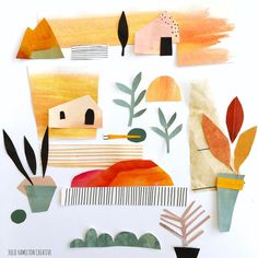 an art project with paper cutouts and plants on the side, including trees, bushes, houses, and mountains