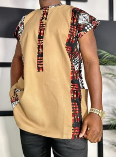 Pair with our Matching ladies  ?s=damola+&post_type=product]fit, for a perfect couple/date look with bae. Description: * Traditional Sleeveless Shirt * In Black Red Tan and White African Kente Print * 2 side pockets. * African print is 100% cotton. Care Instruction: * Hand Wash * In cold water * Wash inside out. * Do not bleach. * Do not tumble dry. Hang to dry. Disclaimer: Pattern placement may vary. African Male Fashion, Couple Date, Kente Print, African Shirts For Men, Classy Outfits Men, African Wear Dresses, African Clothing For Men, African Shirts, Mens Workwear