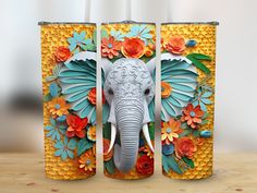 an elephant with flowers on it's trunk is standing in front of two lighters