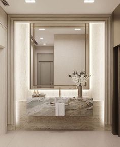 an elegant bathroom with marble counter tops and white walls, along with a large mirror on the wall