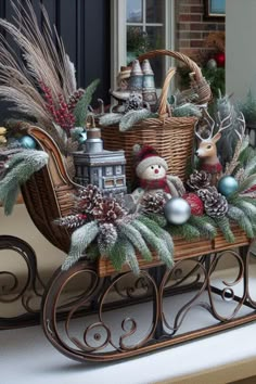 a sleigh filled with christmas decorations sitting on top of a table next to a window