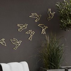 the wall is decorated with gold origami birds