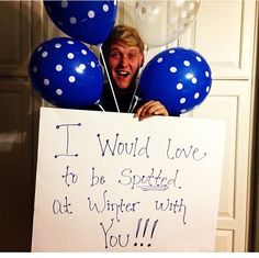 a man holding up a sign that says i would love to be spotted out winter with you