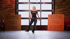 a woman standing in front of a window with the words slow the night on it