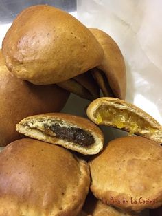 a pile of baked pastries sitting on top of a white paper bag filled with them