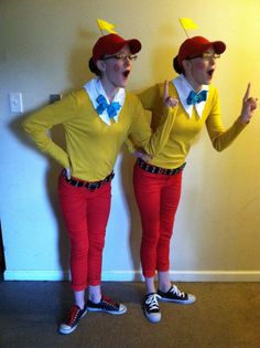 two people in matching outfits standing next to each other