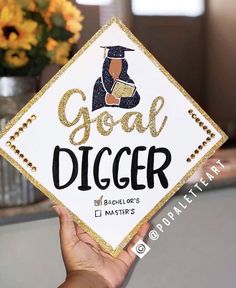 someone holding up a graduation cap that says, goal digger