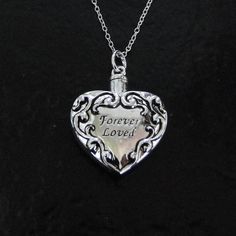 "A necklace that is not only beautiful, but functional! Heart Ash Container Necklace, Cremation jewelry, Pet Ashes. This pendant measures 25x28mm, (1\" wide). It unscrews at the top to hold your precious memories that will rest next to your own heart. I dropped it from a Sterling Silver chain that has a spring clasp and a 'Theresa Mink' signature tag attached. Choose your length in the option bar. Included is a black pouch, funnel, spoon, and toothpick. I also offer the love drop and the infinit Heart Container, Black Pouch, Ashes Necklace, Clean Sterling Silver, Silver Pendant Lighting, Filigree Heart, Pet Ashes, Golden Jewelry, Cremation Jewelry