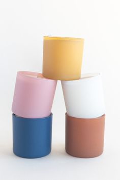 four different colored cups stacked on top of each other