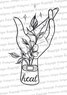 a hand holding flowers with the word heal