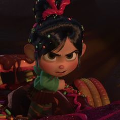 an animated character with black hair and green shirt sitting in front of a pile of candy