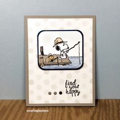 a handmade card featuring a cartoon character fishing