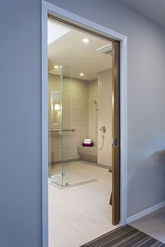 an open door leading to a bathroom with a stand up shower