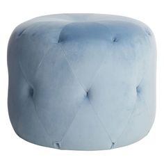 a blue velvet ottoman with diamond stitching