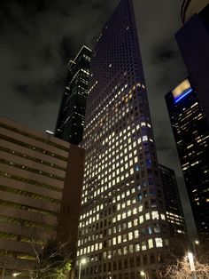 tall buildings lit up at night in the city