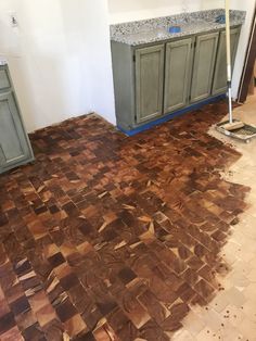 an unfinished kitchen floor is being remodeled