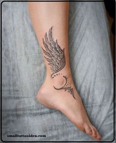 a woman's foot with a tattoo on it and an angel wing above the toe