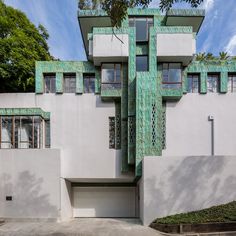 an art deco house with green tiles on the side