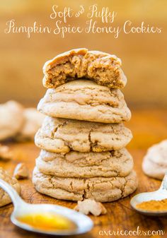 soft and fluffy pumpkin spice honey cookies stacked on top of each other with a spoon