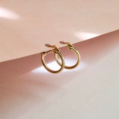 ANTA MARIA HOOP EARRINGS  These gorgeous gold hoop earnings are simple but cute!  Perfect as a gift and for wearing to any occasion - wedding, birthday parties, business events, etc.  −−•−−•−−•−−•−−•−−•−−•−−•−−•−−•−−•−−•−−•−−•−−•−−•−−•−  D E T A I L S   14K gold filled hoop earrings Comes as pair  Hoop size: approximately 13 mm x 12 mm Hoop thickness: approximately 2 mm  P A C K A G I N G  The product comes in a small box  Ready to gift Shipped in a bubble mailer to secure the product Hypoallergenic Small Hoop Earrings In 14k Gold Filled, Simple Design 14k Gold Earrings, Minimalist 14k Rose Gold Huggie Earrings, Gold Plated Minimalist Round Cartilage Earrings, Gold Minimalist Huggie Earrings, Gold Minimalist Round Huggie Earrings, Minimalist Yellow Gold Cartilage Earrings For Everyday, Minimalist Small Hoop Yellow Gold Jewelry, Classic Small Hoop Earrings In 14k Gold Filled