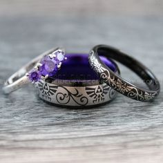 three wedding rings with purple stones on them